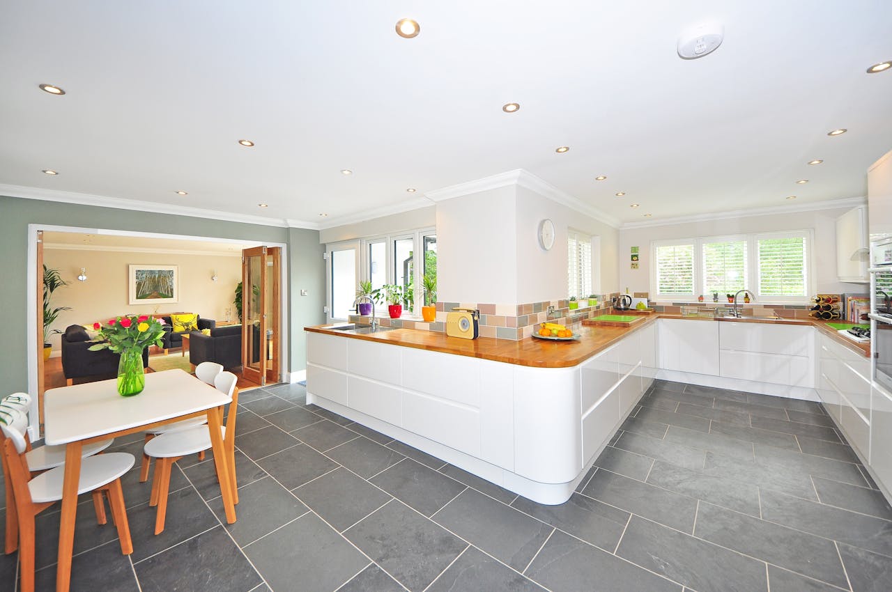 gallery-03 A spacious modern kitchen with elegant interiors featuring a dining table and luxurious design.